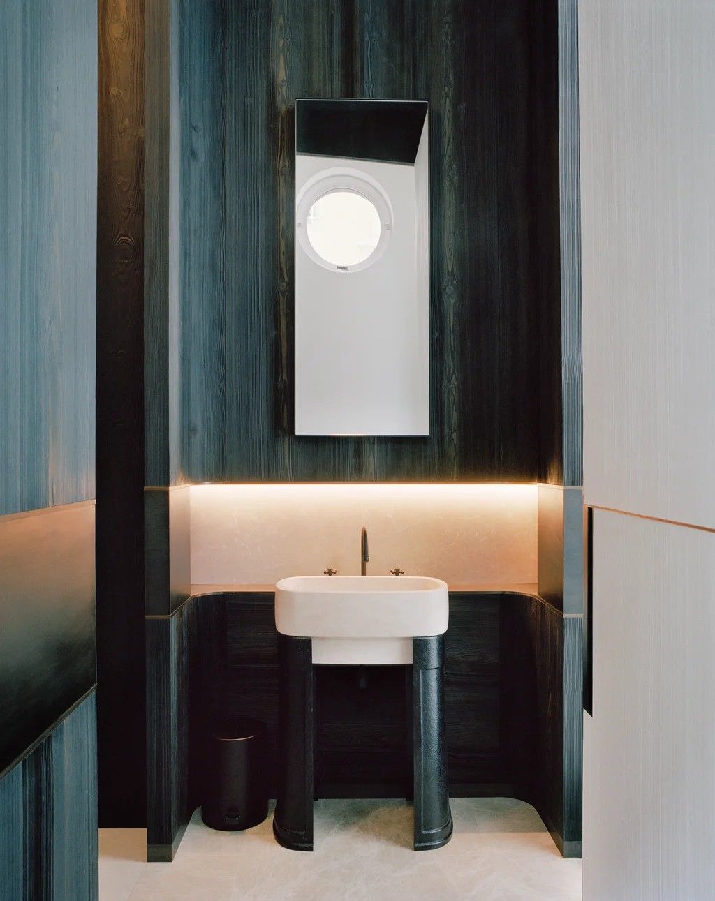 Minimalist marble sink with matte black faucet and integrated raised platform