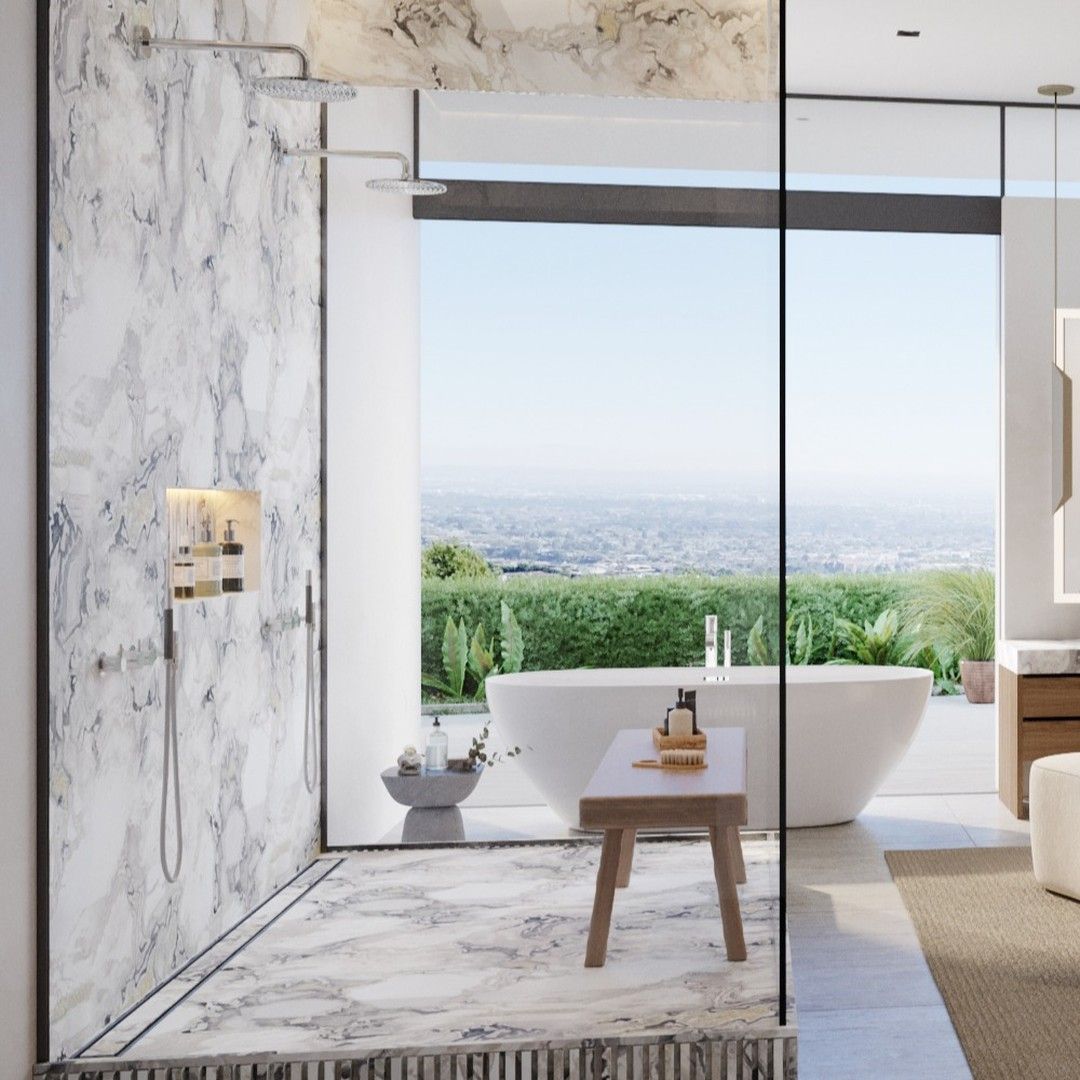 A luxurious modern bathroom featuring a white freestanding solid surface (Corian-like) bathtub overlooking a panoramic view, alongside a marble-clad walk-in shower with a sleek, integrated square shower tray base.