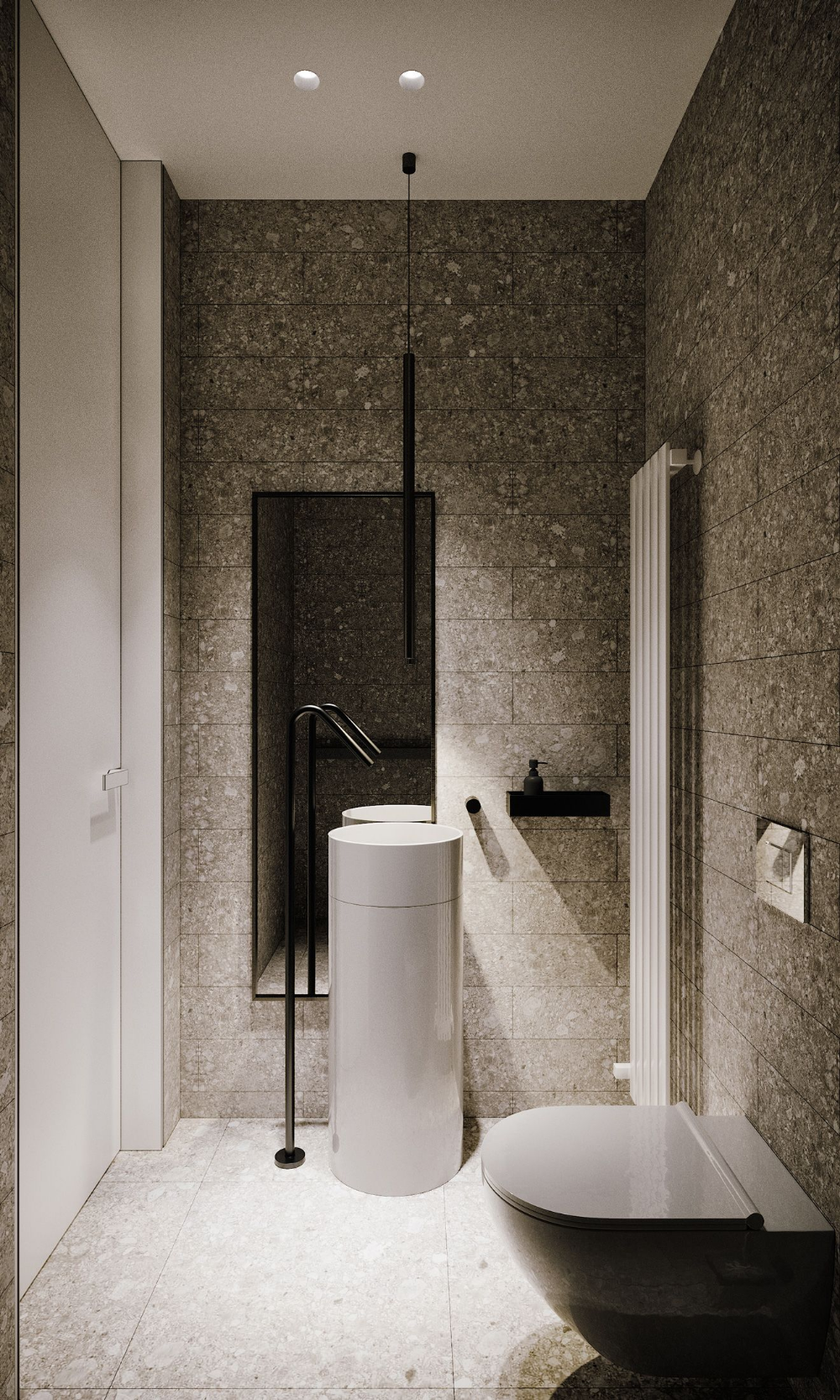Modern minimalist bathroom featuring a white round pedestal sink with a matte black floor-mounted faucet, against a backdrop of Ceppo di Gré style grey terrazzo tiles, a narrow black-framed mirror, and a black pendant light.