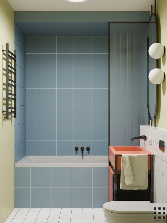 Modern kids bathroom with sky-blue tiled built-in tub, coral orange basin and matte-black fixtures