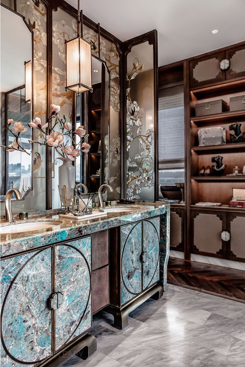 Luxurious New Chinese style bathroom featuring a dark solid wood double vanity with round Amazonite panels and classic pulls, set against a backdrop of mirrors with floral and bird motifs.