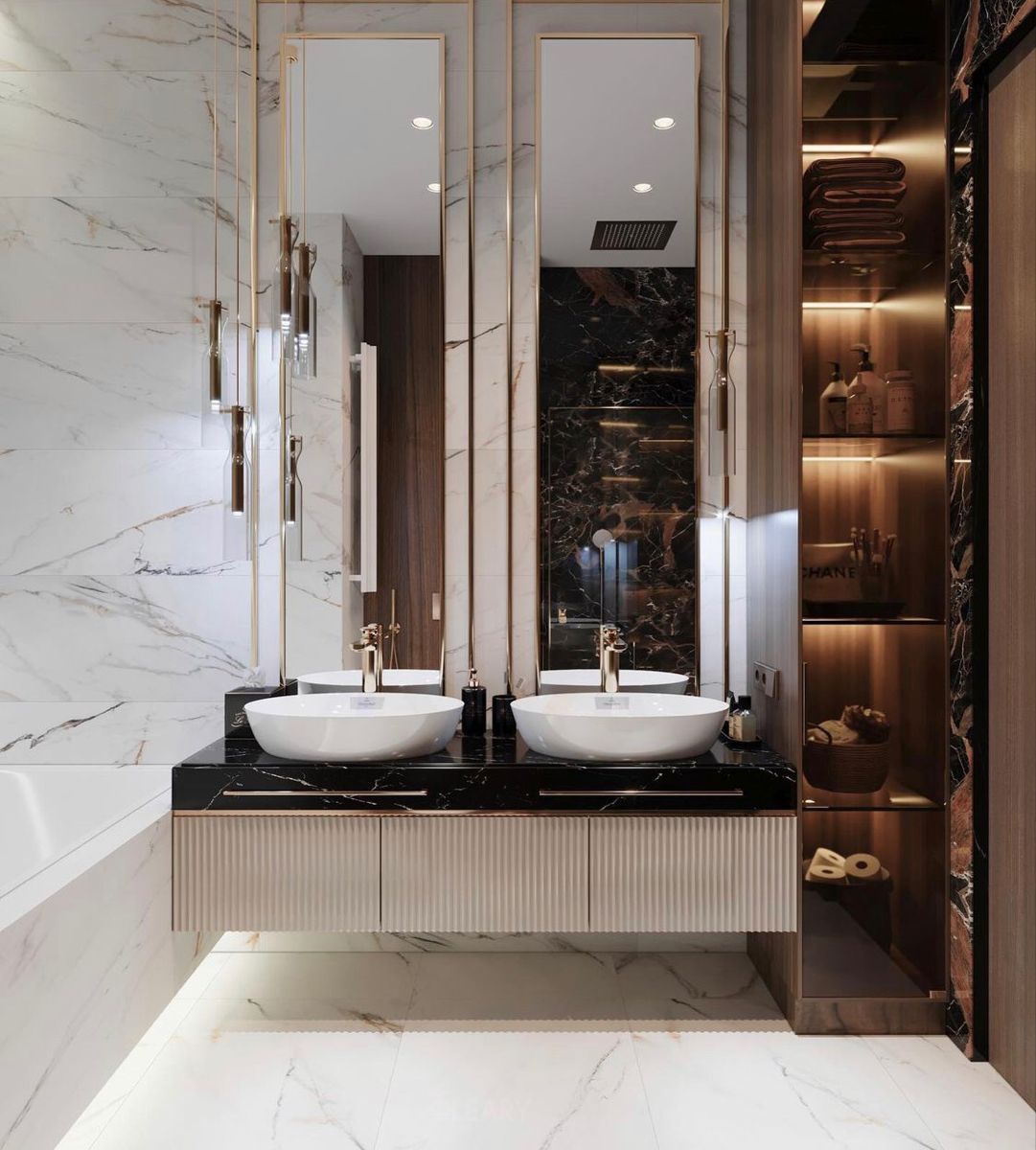 A luxury bathroom designed by Ferris Rafauli, featuring a curved floating double vanity, marble countertop, artistic sculptural sconces, and a modern pendant light.