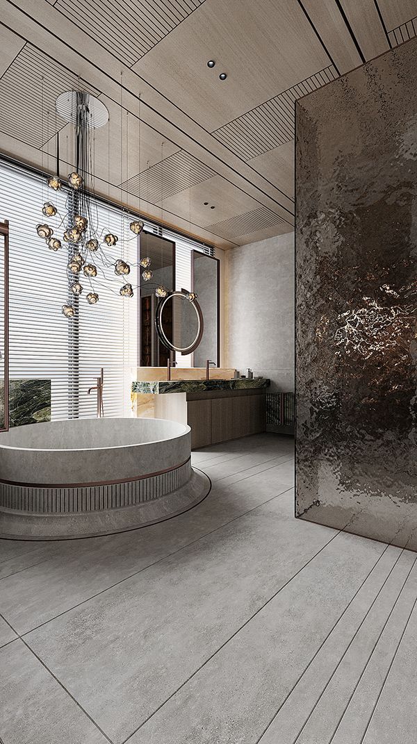 A luxury bathroom featuring a large, round, fluted stone bathtub placed under a sculptural glass chandelier, with a textured metallic accent wall and a wood-paneled ceiling.
