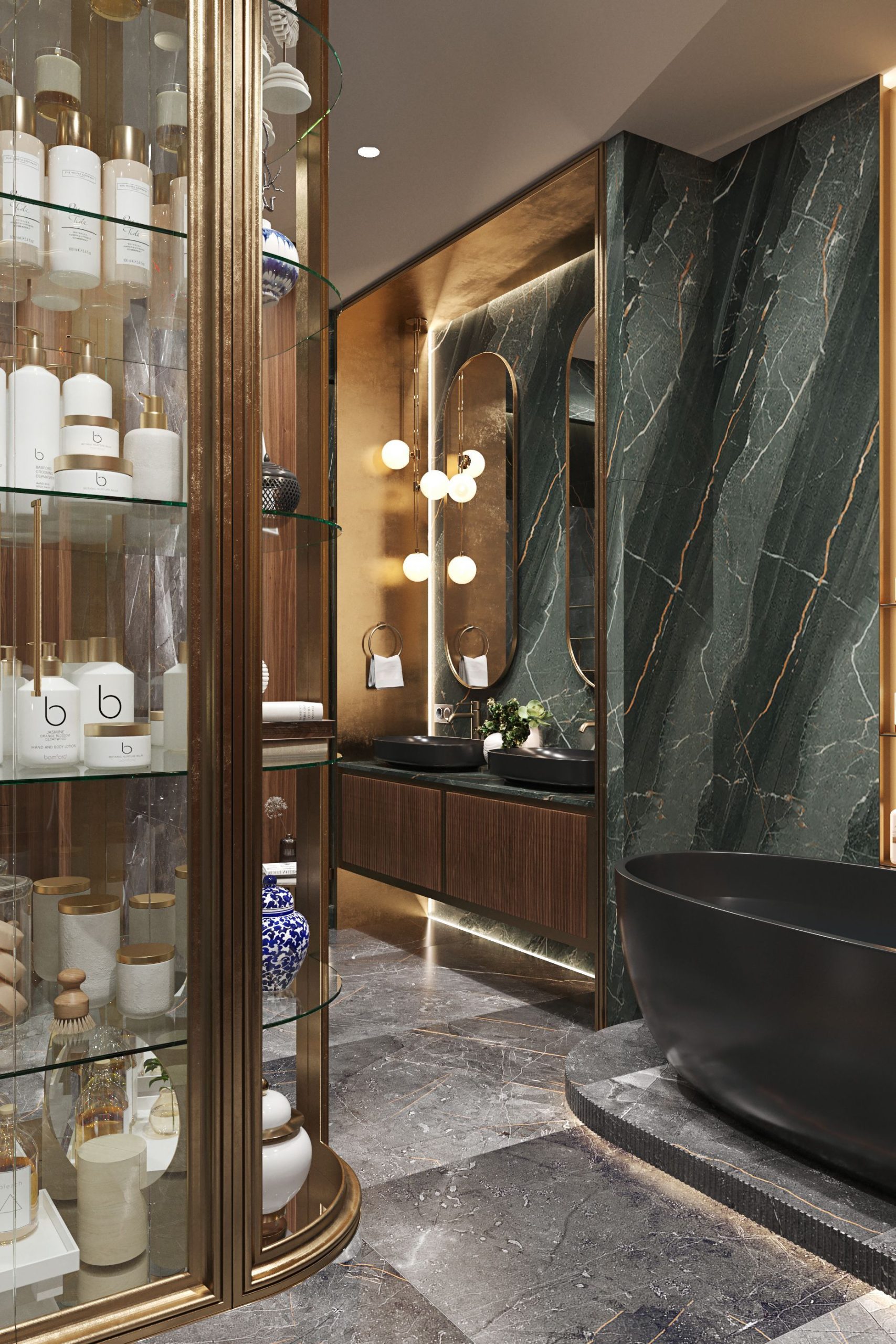 Ultra-luxurious Art Deco-inspired bathroom featuring a dark fluted wood double vanity with a dark green marble countertop, two matte black surface-mounted sinks, elegant pill-shaped gold-framed mirrors, and striking spherical gold and white globe wall sconces, all set against dramatic dark green marble walls. A black freestanding tub is partially visible.