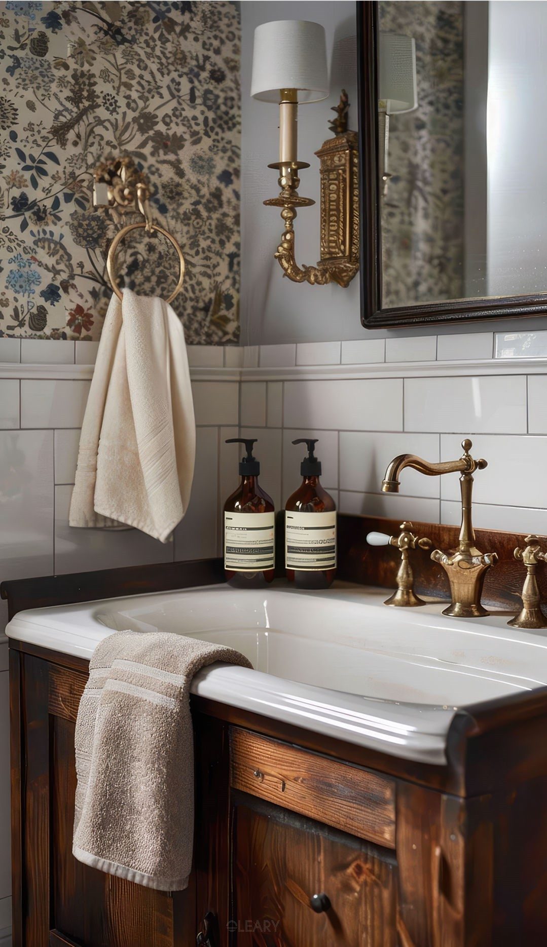 Vintage brass faucet and solid wood vanity cabinet paired with floral wallpaper and modern washbasin, showcasing refined lifestyle aesthetics.