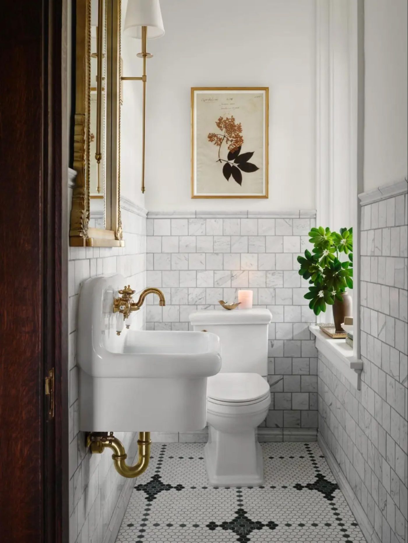 Small bathroom with classic hexagon floor tiles, wall-mounted sink, gold faucet, and modern minimalist style

