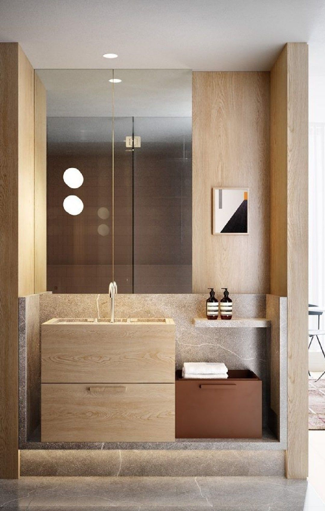 A modern minimalist bathroom featuring a light natural wood floating vanity with two drawers and an integrated light grey stone sink and countertop. The area is elevated on a stone platform, with a large frameless mirror, and walls clad in matching light wood panels, evoking a serene, zen-like ambiance.