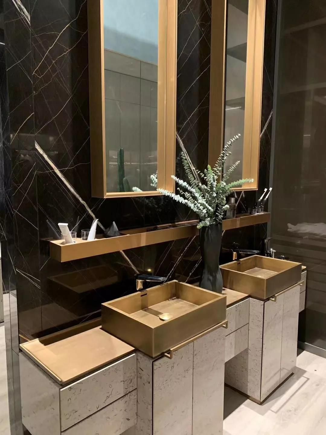 Golden Grandeur: Sculpting Luxury Bathrooms with Brass Sinks, Travertine Vanities & Dark Marble