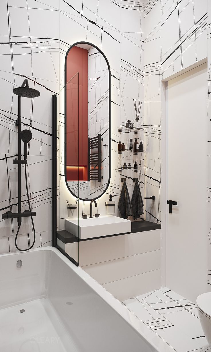 A modern, graphic black and white bathroom featuring abstract scribble-patterned tiles, a complete matte black shower system, a minimalist vanity, and a black-framed oval mirror.