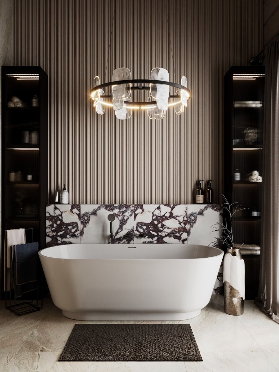 A luxurious modern bathroom featuring a large, sculptural ring chandelier with glass elements hanging over a white freestanding soaking tub, set against a fluted wall and a Calacatta Viola marble backsplash.