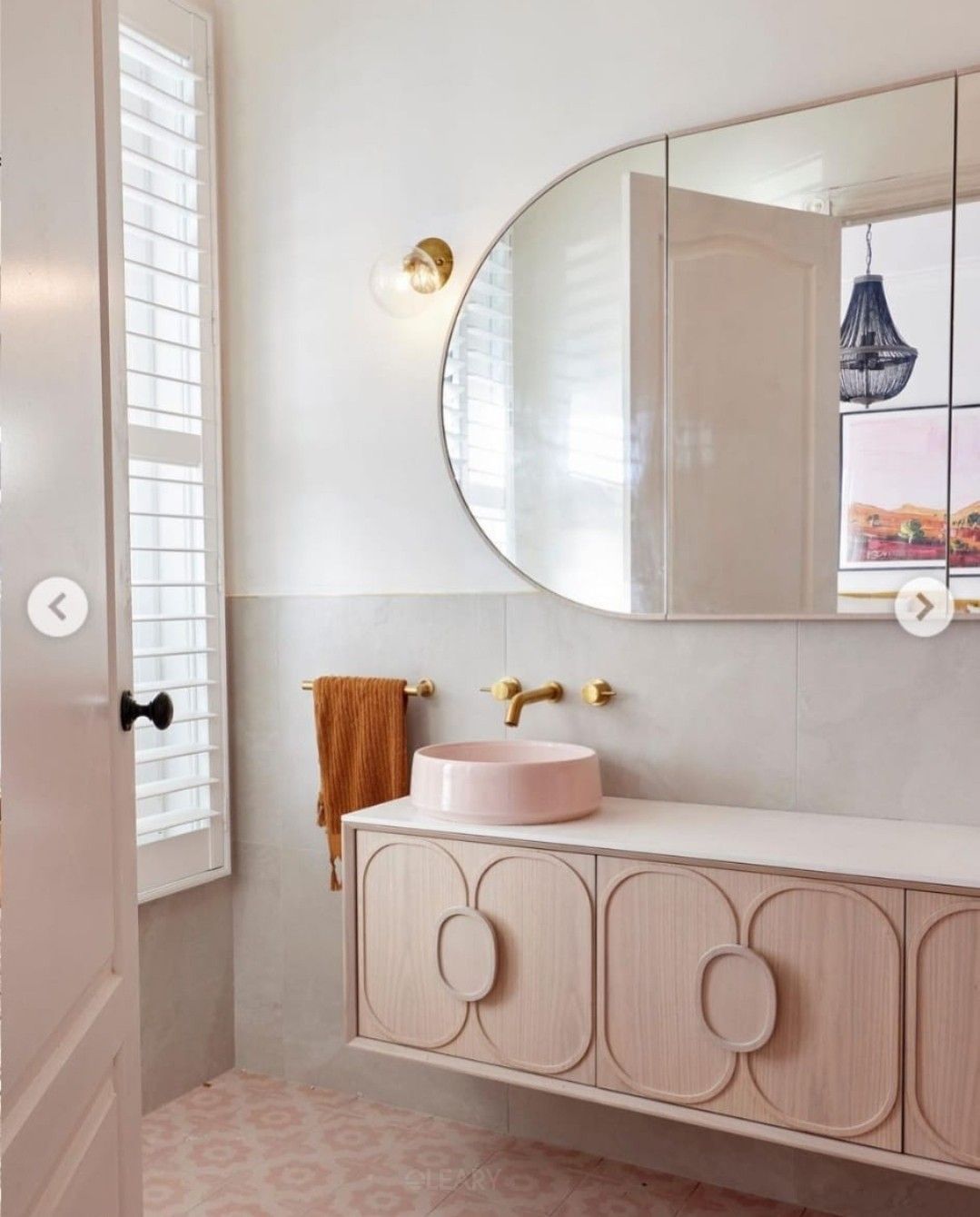 floating bathroom vanity with pink countertop basin and carved cabinet doors