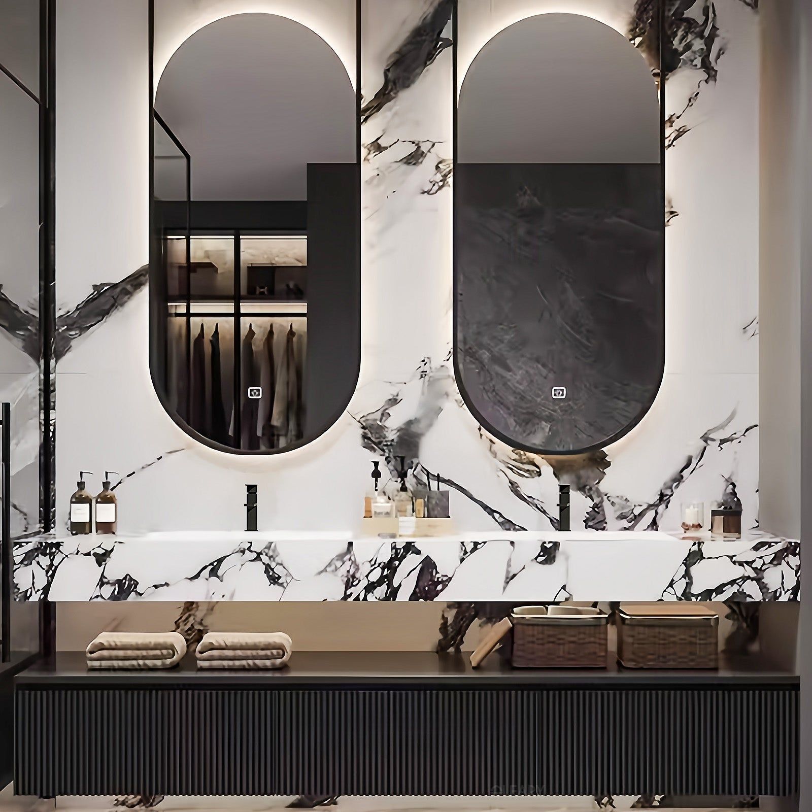 Luxury double bathroom vanity with black and white marble countertop, integrated sinks, matte black faucets, pill-shaped backlit mirrors, and fluted black cabinet doors.