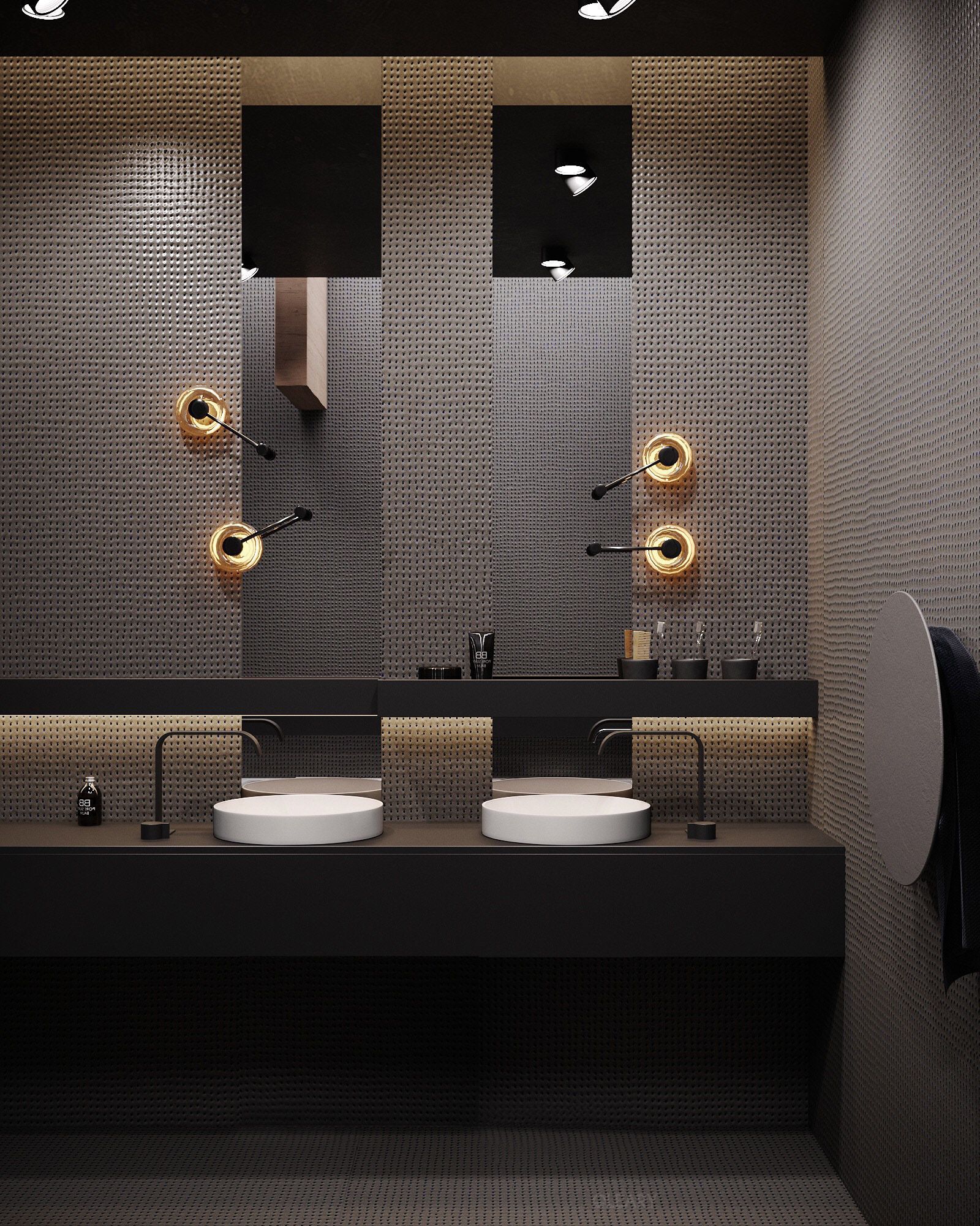 Modern industrial bathroom featuring a double vessel sink floating vanity with white round vessel sinks, black wall-mounted faucets, a grey textured accent wall, and gold long-arm sconces.