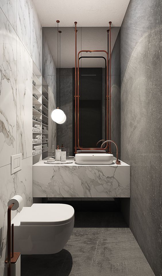 Modern small bathroom with a floating white marble vanity, a white vessel sink, and rose gold fixtures, including a tall mirror.